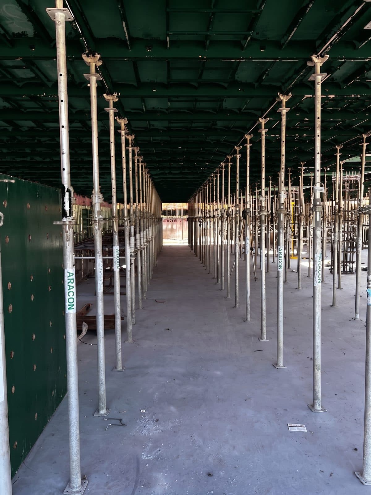 A run of props carried under a supreme deck soffit the length of a floor plate