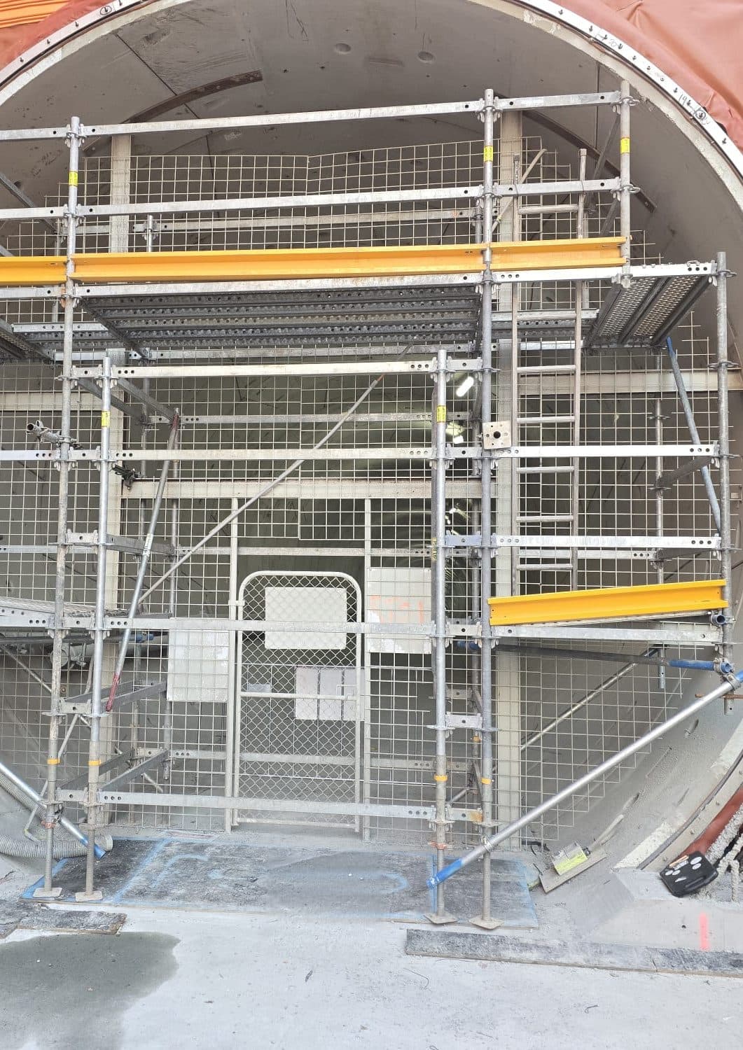 An X8 tower built inside a circular tunnel portal, decked and meshed
